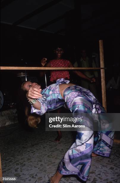 German countess, model and film star Veruschka, limbo dancing, wearing a Pucci printed outfit. She became a photographer of note after her modelling...