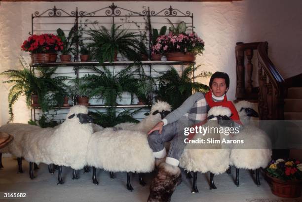 In a chalet in the ski resort of Gstaad, dress designer Valentino relaxes on a sofa made of sheep. He started in the trade working for Desses and...