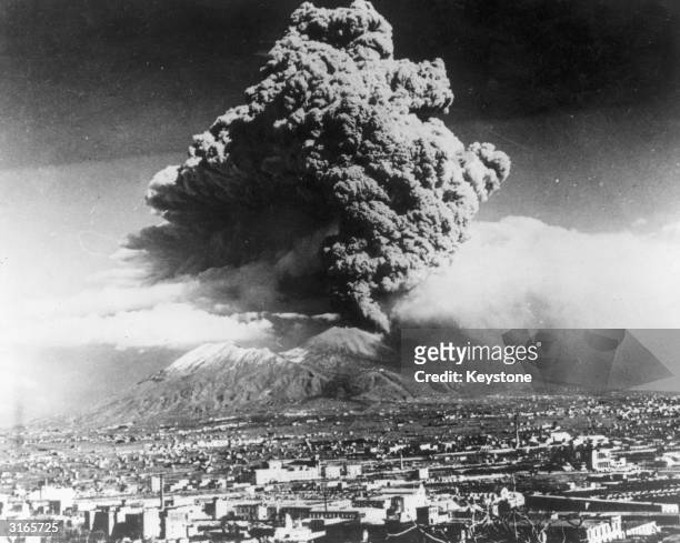 Cloud of ash hangs over Vesuvius during its worst eruption in more than 70 years. In the foreground is the city of Naples. The nearby towns of Massa...