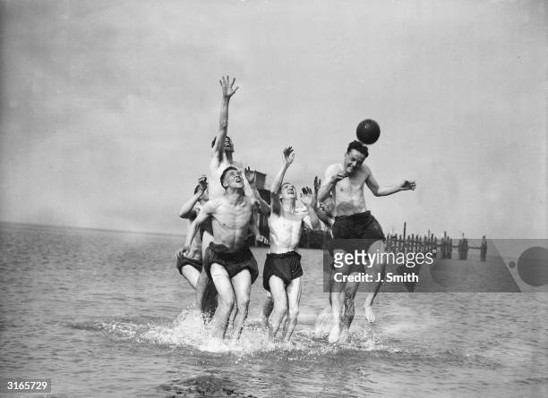 Southport football club players training in the sea.