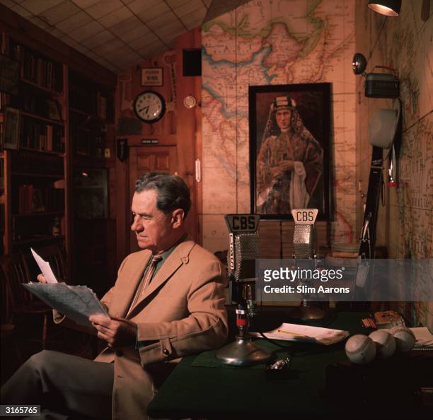 American journalist and radio broadcaster, Lowell Thomas, whose news stories made the British soldier T E Lawrence, whose picture is on the wall...