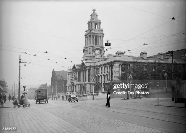 Policeman directing traffic outside the townhall at Stockport.