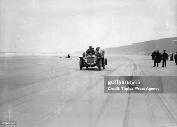 Wilson driving along Magilligan Strand in an Austin car on the second day of the Irish Auto Club Reliability Trials.