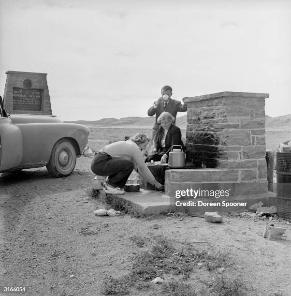 American motorists stop for refreshments on New Mexico's Blue Star Memorial Highway at a roadside interval where ovens are available for food...