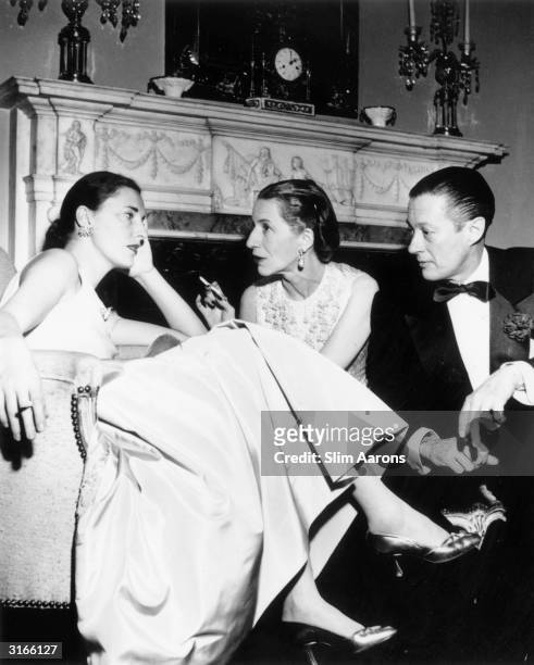 From left to right, Slim Hawks chatting with Vogue editor Diana Vreeland and her husband Reed at Kitty Miller's New Year's Eve party in Park Avenue,...