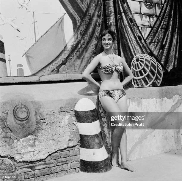 Year-old starlet Jackie Collins, the younger sister of Joan Collins, cools off at the Oasis swimming pool in London's Holborn. She later made a name...