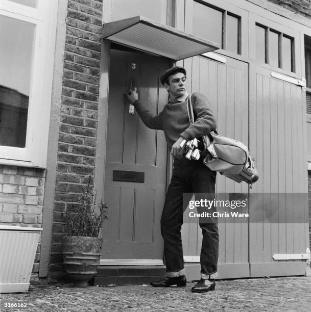 Scottish actor Sean Connery, the new face of superspy James Bond, leaves his basement flat in London's NW8 for a game of golf, his favourite pastime.