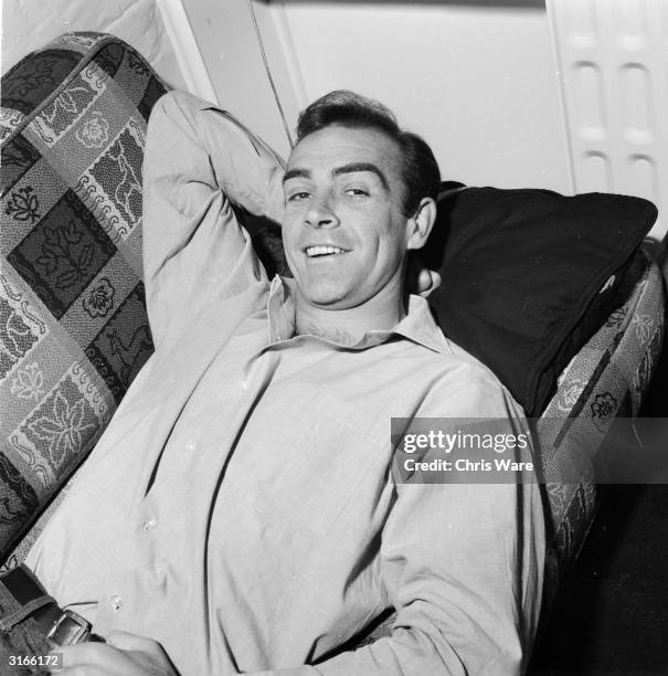 Scottish actor Sean Connery, the new face of superspy James Bond, relaxes in his basement flat in London's NW8.