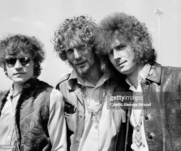 The members of the rock group Cream, Jack Bruce, Ginger Baker and Eric Clapton at London Airport on their way to Los Angeles.