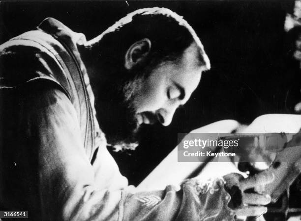 Mystic and Stigmatic, Capuchin friar Padre Pio celebrating mass. The stigmata on his hands can be seen. He bears on his body the five marks of the...