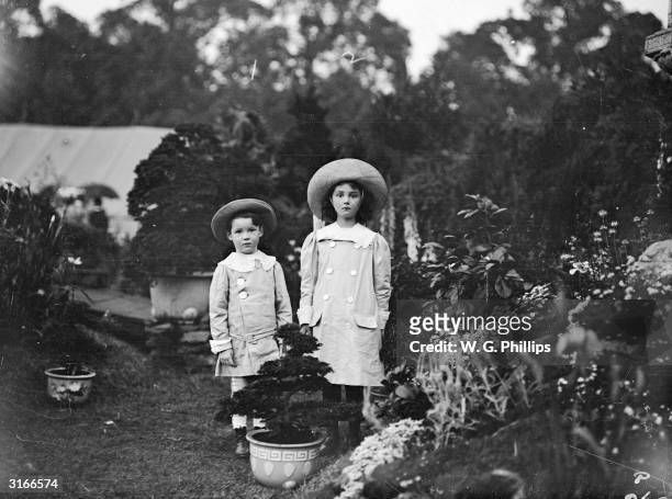 Two little girls dressed in Edwardian daywear.