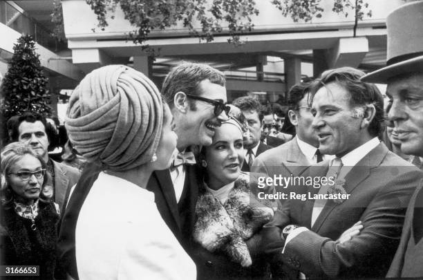 From left to right, opera singer Maria Callas with actors Peter O'Toole, Elizabeth Taylor and Richard Burton at a race meeting in Longchamp, Paris.
