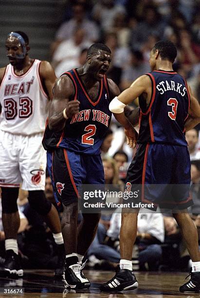 Forward Larry Johnson and guard John Starks of the New York Knicks in action against the Miami Heat during an NBA playoff game at the Miami Arena in...