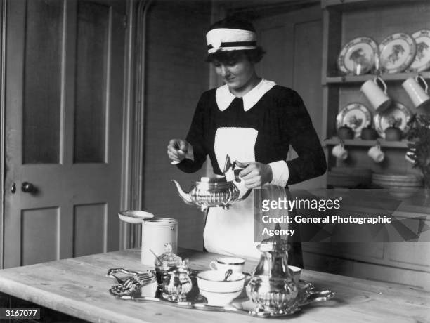 Luise Horner, an Austrian working as a maid in England, prepares afternoon tea.