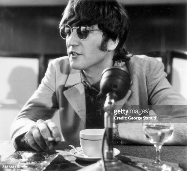 English pop star John Lennon at a press conference at London Airport after the Beatles' return from Manila.