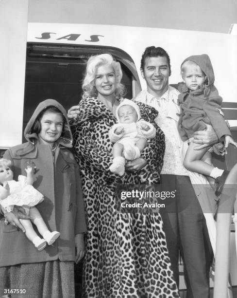 American actress Jayne Mansfield at Los Angeles airport with her husband, muscleman Mickey Hargitay and their children Jayne Marie, Zoltan and Miklos...