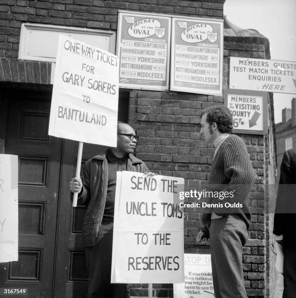 Peter Hain leader of the Young Liberals and member of the 'Stop the Tour 1970' committee talks to a fellow anti-apartheid demonstrator outside Surrey...