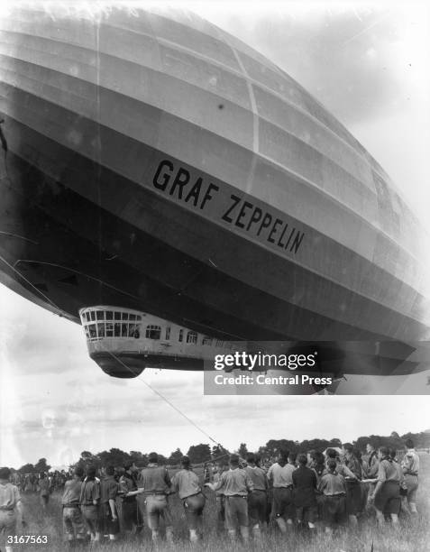The Graf Zeppelin is guided to its mooring by British boy scouts, at Hanworth, Middlesex.