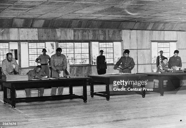 Lieutenant General William K Harrison and Senior Communist Delegate General Nam Il during the signing of the Korean Armistice at the truce village of...