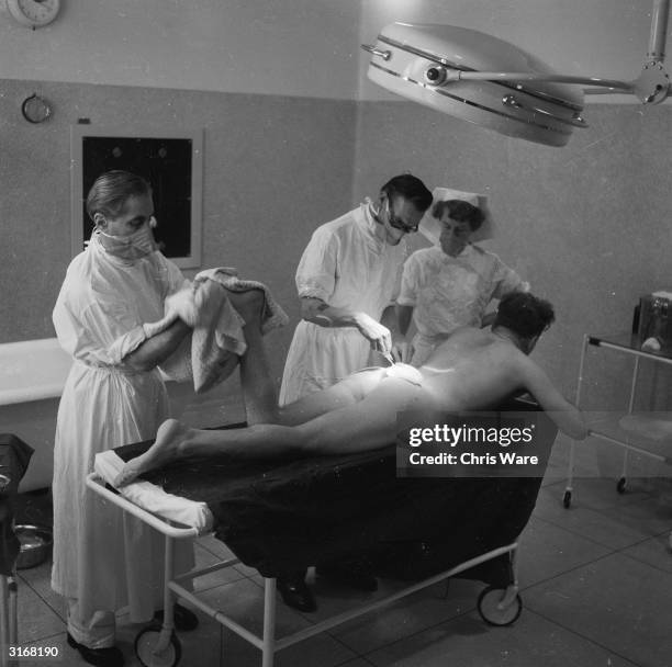 Plastic surgery operation in progress at the Plastic and Burns Centre in a newly-built wing at Queen Mary's Hospital, Roehampton. The unit deals with...