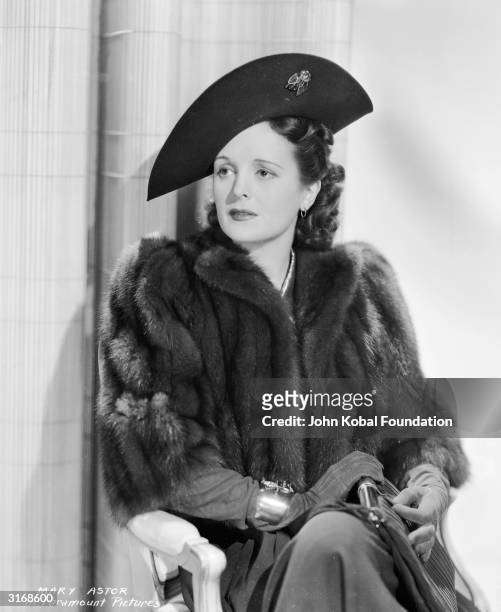 American actress Mary Astor wearing a fur coat, hat and gloves.