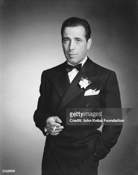 American actor Humphrey Bogart wearing a tuxedo and bow tie.