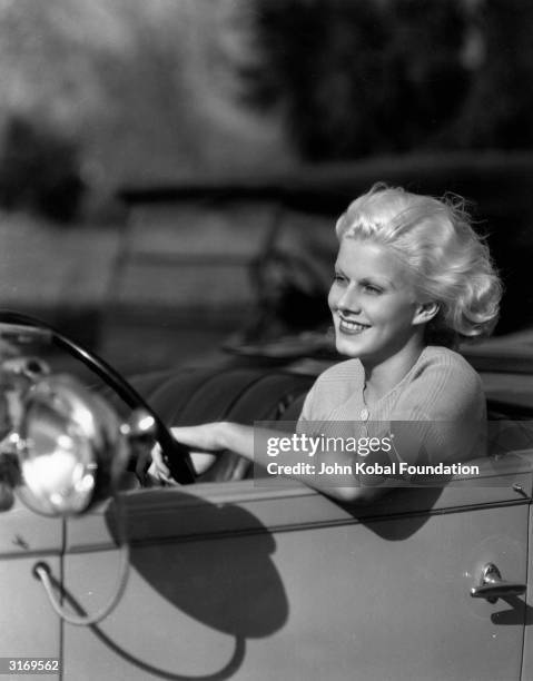 Platinum blonde American actress Jean Harlow , born Harlean Carpentier, takes a drive.