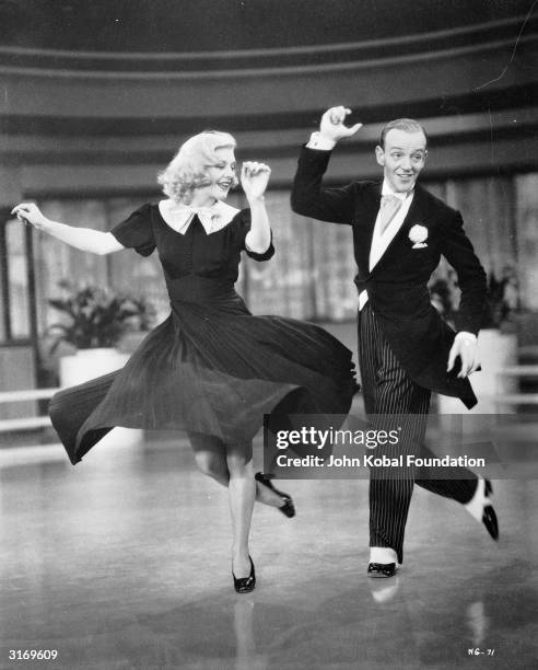 Ginger Rogers as Penelope 'Penny' Carroll and Fred Astaire as John 'Lucky' Garnett dancing together in the RKO film 'Swing Time' directed by George...