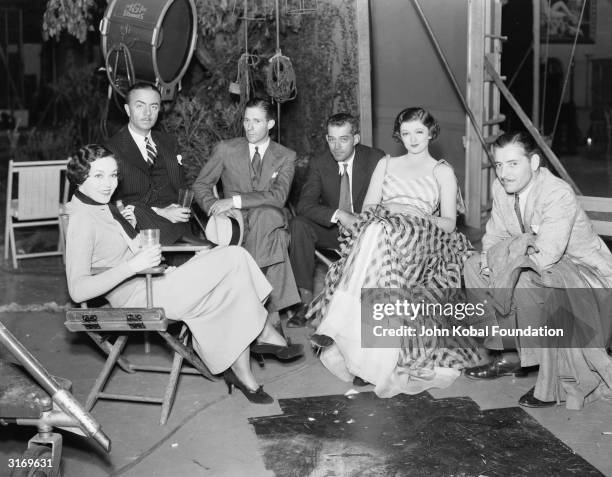 Actors Maureen O'Sullivan , William Powell , Myrna Loy and Ronald Colman on the set of 'The Thin Man' with the director, W. S. Van Dyke.