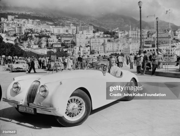 American actor Van Johnson, who became very popular during the war due to the absence of the established leading men, poses in his luxurious sports...