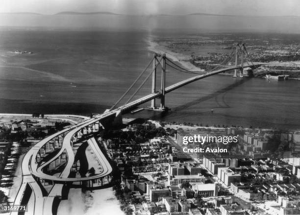 An aerial view of the nearly completed Verrazano Narrows Bridge from the Brooklyn side looking towards Staten Island. The three mile long structure...
