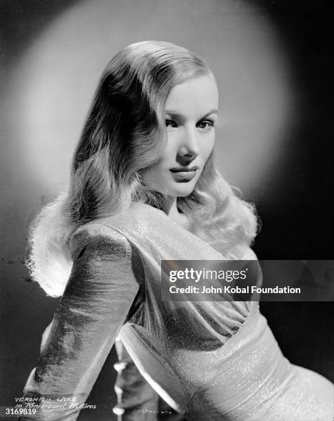 American actress Veronica Lake wearing a dress by legendary Hollywood costume designer Edith Head for her role in 'This Gun For Hire'.