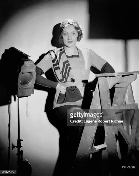 Marlene Dietrich behind the scenes with hands on hips.