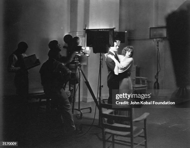 Swedish born American actress Greta Garbo and John Gilbert during the filming of 'A Woman of Affairs'. The pair's on-screen passion reflects their...