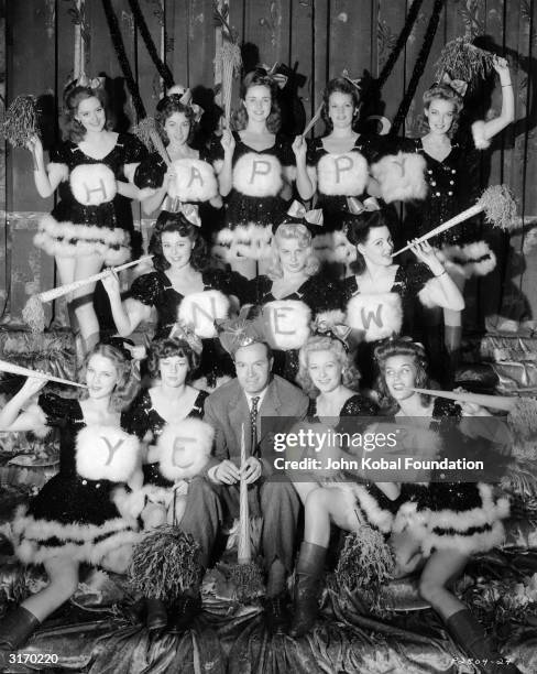 American comedian and actor Bob Hope surrounded by seasonally dressed Louisiana belles who appeared in the film 'Louisiana Purchace', directed by...