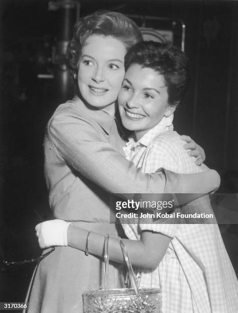 British actress Deborah Kerr hugging her fellow star, Jean Simmons, on the set of her latest film 'Tea and Sympathy'.