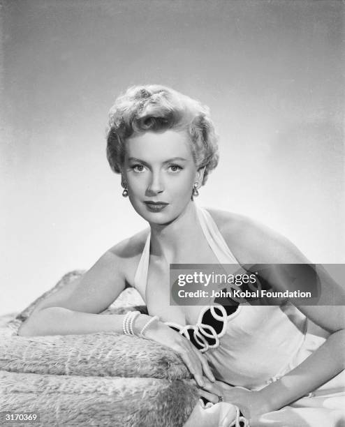 British actress Deborah Kerr in the costume for her role in 'From Here to Eternity', where she played a passionate adulteress having an affair with...