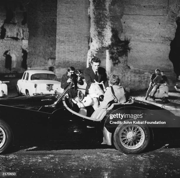 Swedish actress Anita Ekberg plays glamorous movie star Sylvia in 'La Dolce Vita', directed by Federico Fellini. In this scene she is harassed by the...