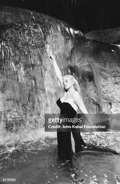 Swedish actress Anita Ekberg plays the glamorous Sylvia in the fountain scene from 'La Dolce Vita', directed by Federico Fellini.