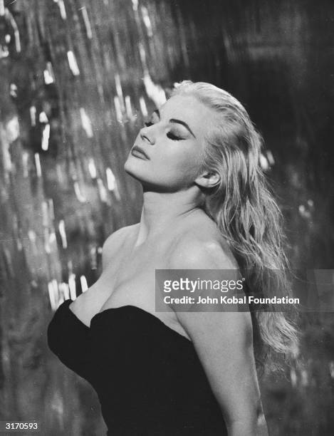 Swedish actress Anita Ekberg plays the glamorous Sylvia in the fountain scene from 'La Dolce Vita', directed by Federico Fellini.