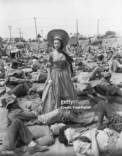 British actress Vivien Leigh surrounded by wounded Confederate soldiers in her role as Scarlett O'Hara in the American civil war epic 'Gone With the...
