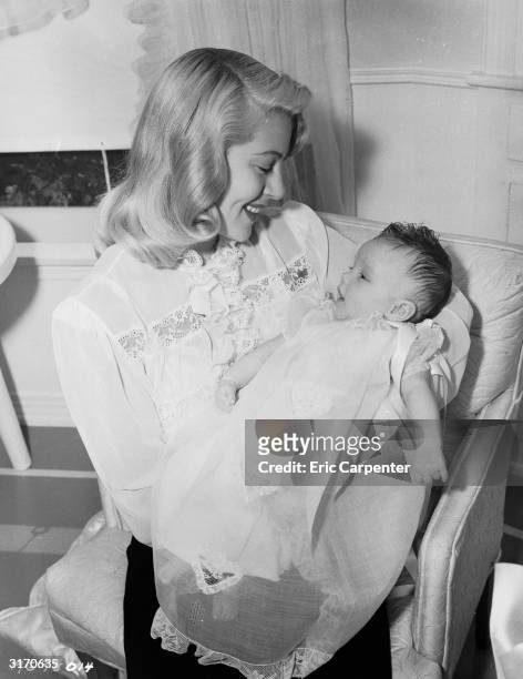Hollywood actress Lana Turner cradles her new born daughter Cheryl Crane. In 1958, Cheryl would be tried for the murder of her mother's boyfriend,...