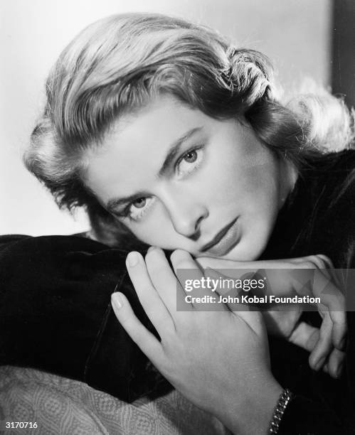 Film star Ingrid Bergman resting her head on her hands.