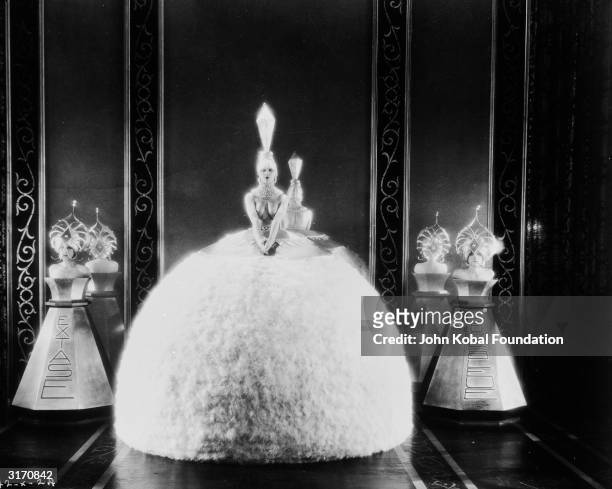 Women in elaborate costumes dressed as perfume bottles for the silent romantic comedy 'Bright Lights', directed by Robert Z Leonard. The bottles are...