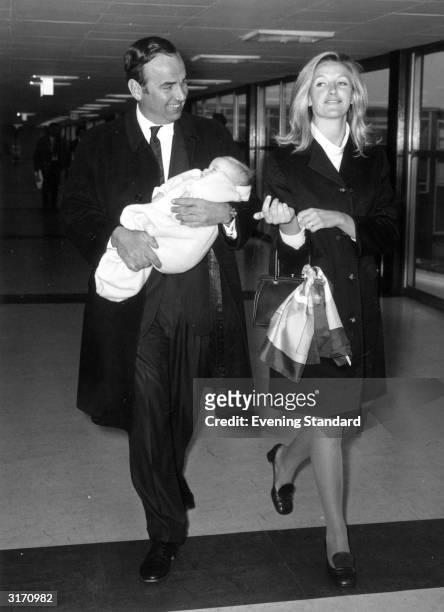 Australian businessman and media tycoon Rupert Murdoch with his wife, Anna and their baby daughter, Elizabeth, at London Airport.