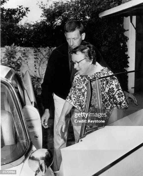 Marilyn Monroe's housekeeper, Eunice Murray and handyman Norman Jeffries, leaving the Monroe house after the film star's death.