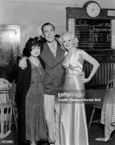 The 'Blonde Bombshell' Jean Harlow with director Jack Conway and writer Anita Loos during the making of the MGM film 'Red Headed Woman'.