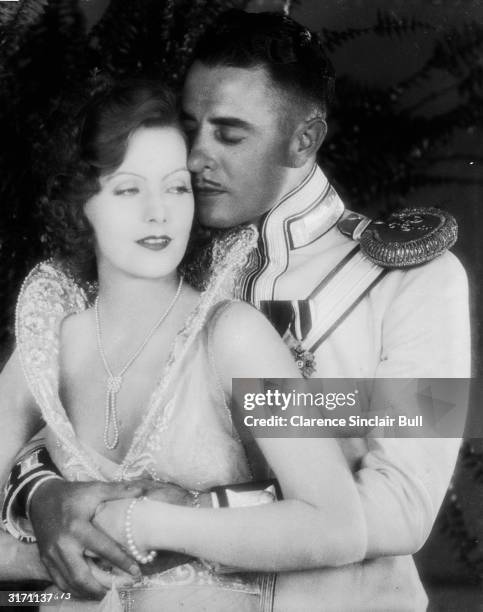 Swedish-American actress Greta Garbo plays Anna Karenina in the romantic drama 'Love', directed by Edmund Goulding. She embraces her on-screen lover...