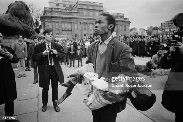 Members of the anti-apartheid movement commemorate the tenth anniversary of the Sharpeville massacre with a re-enactment outside South Africa House...