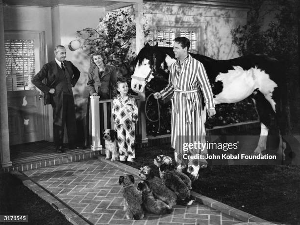 Jonathan Hale , Penny Singleton, Larry Simms and Arthur Lake in a scene from the movie 'Blondie', directed by Frank Strayer and based on Chic Young's...